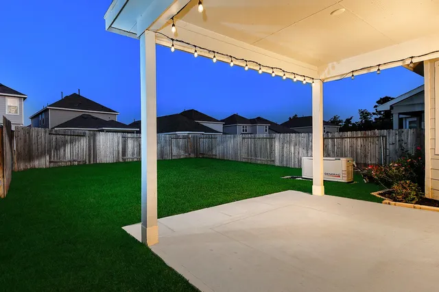a view of a house with backyard and porch