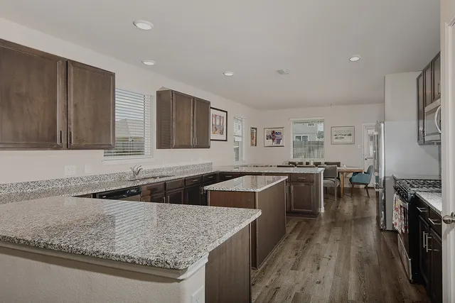 a kitchen with lots of counter space and wooden floor