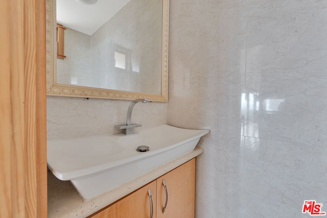 17728 Ridgeway Road Granada Hills, CA 91344 - Photo 12 of 54 a bathroom with a sink and a mirror