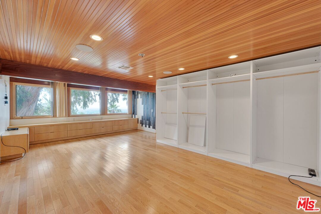 17728 Ridgeway Road Granada Hills, CA 91344 - Photo 14 of 54 a view of an empty room with wooden floor and a window