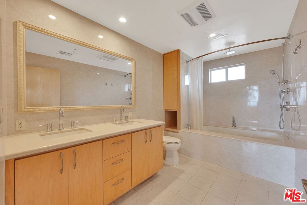 17728 Ridgeway Road Granada Hills, CA 91344 - Photo 16 of 54 a bathroom with a double vanity sink toilet mirror and bathtub