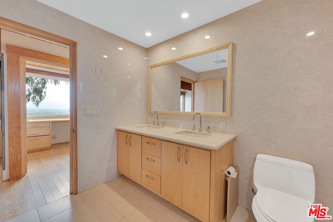 17728 Ridgeway Road Granada Hills, CA 91344 - Photo 18 of 54 a bathroom with a toilet sink and mirror