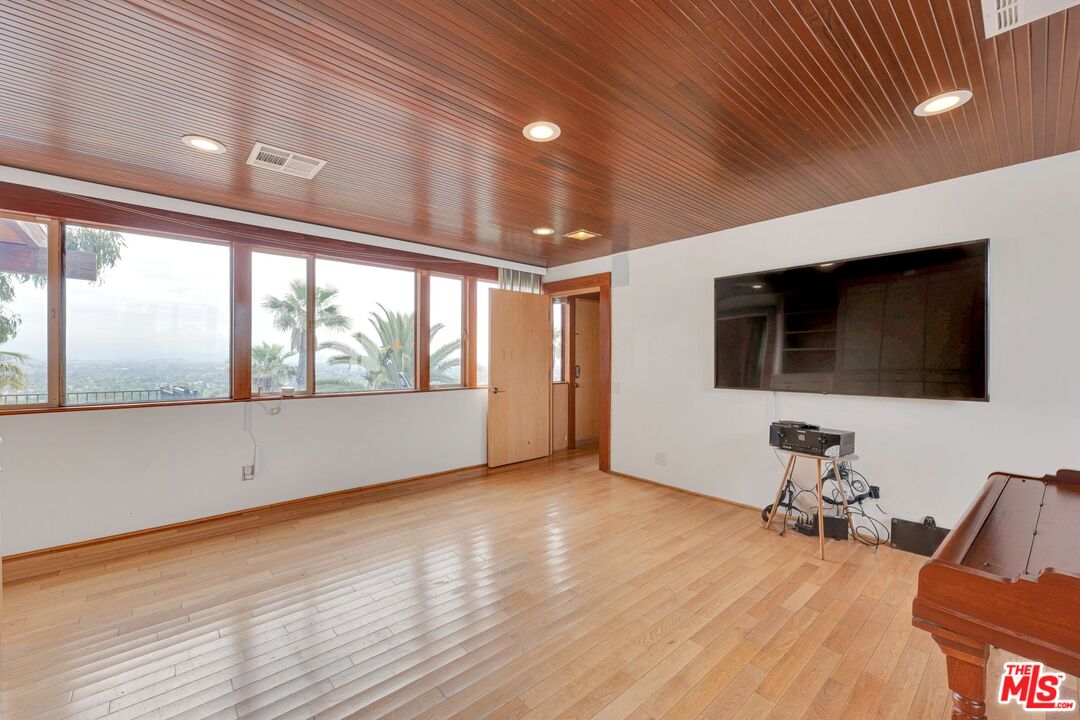 17728 Ridgeway Road Granada Hills, CA 91344 - Photo 20 of 54 a view of a room with wooden floor and windows