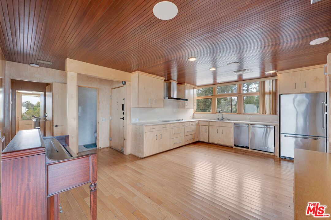 17728 Ridgeway Road Granada Hills, CA 91344 - Photo 2 of 54 a kitchen with stainless steel appliances a refrigerator and a wooden floor