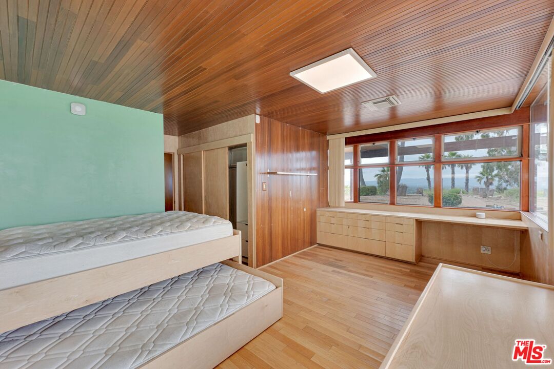 17728 Ridgeway Road Granada Hills, CA 91344 - Photo 21 of 54 a spacious bedroom with a large bed and a large window