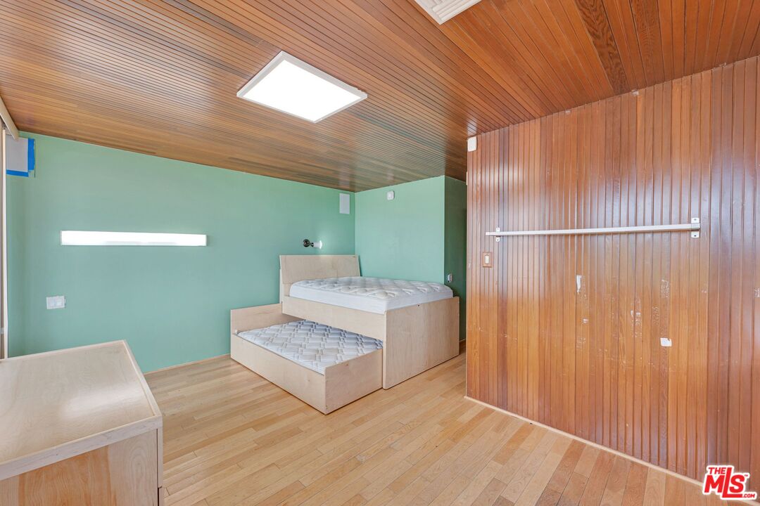 17728 Ridgeway Road Granada Hills, CA 91344 - Photo 22 of 54 a spacious bedroom with a bed and a dresser