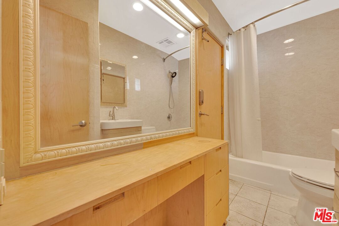 17728 Ridgeway Road Granada Hills, CA 91344 - Photo 28 of 54 a bathroom with a bathtub and a shower
