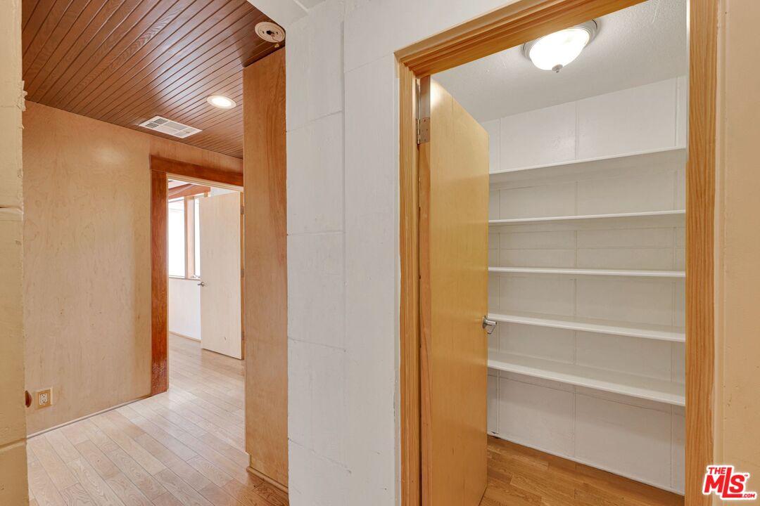 17728 Ridgeway Road Granada Hills, CA 91344 - Photo 30 of 54 a view of a hallway with wooden floor and closet