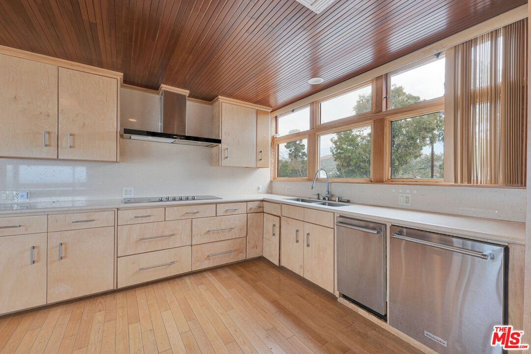 17728 Ridgeway Road Granada Hills, CA 91344 - Photo 3 of 54 a kitchen with granite countertop white cabinets and a large window