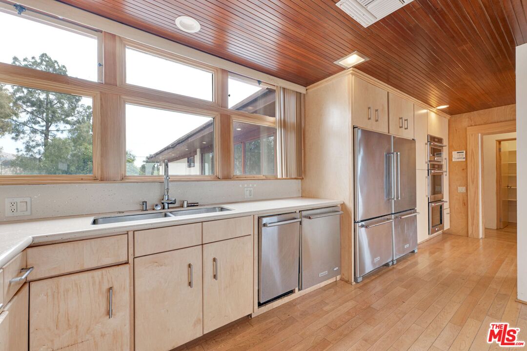 17728 Ridgeway Road Granada Hills, CA 91344 - Photo 4 of 54 a kitchen with white cabinets and wooden floors