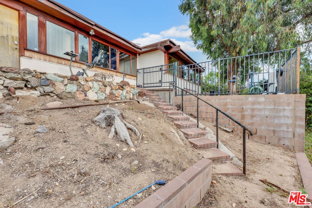 17728 Ridgeway Road Granada Hills, CA 91344 - Photo 44 of 54 a view of wooden house with large trees