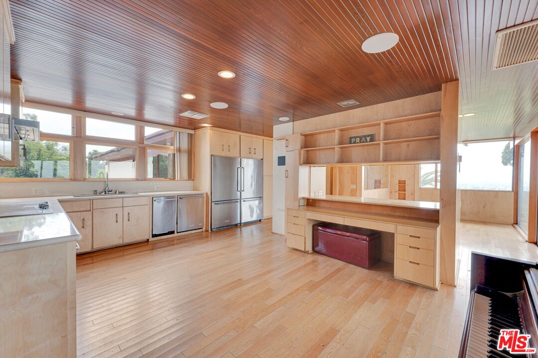 17728 Ridgeway Road Granada Hills, CA 91344 - Photo 6 of 54 a large kitchen with stainless steel appliances wooden floor and a large window