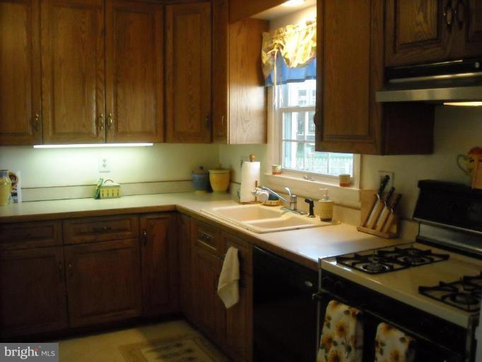 4430 Kendi Road Nottingham, MD 21236 - Photo 2 of 13 a kitchen with a sink stove top oven and cabinets