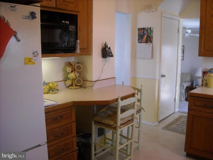 4430 Kendi Road Nottingham, MD 21236 - Photo 3 of 13 a kitchen with a refrigerator and a stove top oven