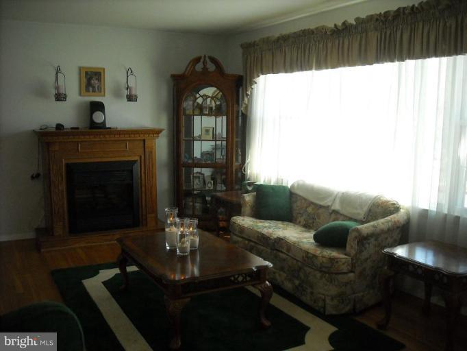 4430 Kendi Road Nottingham, MD 21236 - Photo 5 of 13 a living room with furniture and a fireplace
