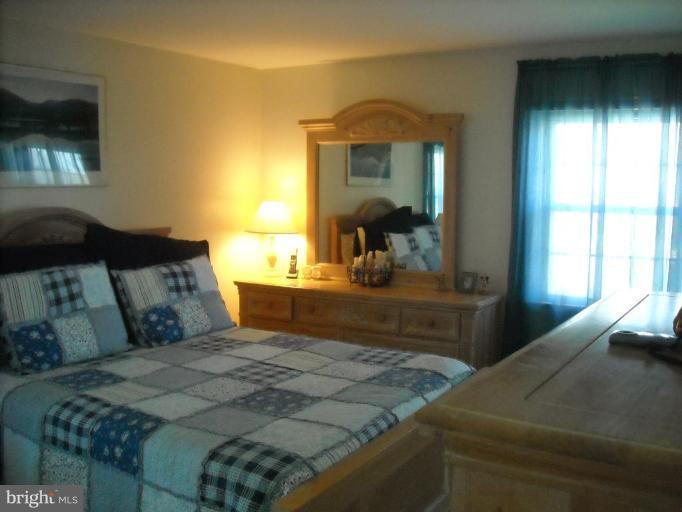 4430 Kendi Road Nottingham, MD 21236 - Photo 6 of 13 a bedroom with a bed and a large mirror next to a window