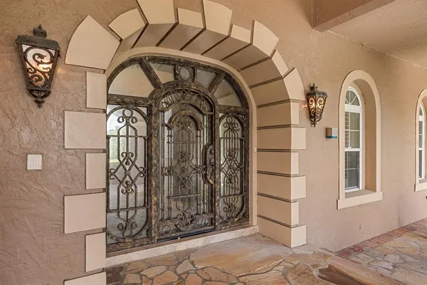 a kitchen with stainless steel appliances granite countertop a stove oven a dining table and chairs with wooden floor