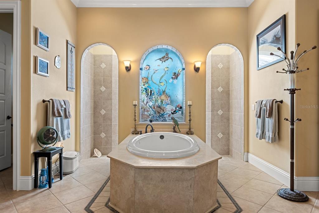 9400 Laws Road Clermont, FL 34714 - Photo 24 of 58 a bathroom with a tub a sink and a mirror