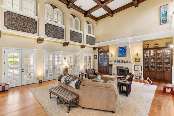 a living room with lots of books and a fireplace