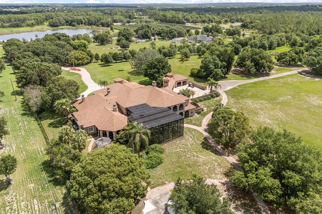 9400 Laws Road Clermont, FL 34714 - Photo 4 of 58 an aerial view of a house with a yard and lake view