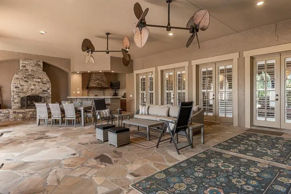 a living room with furniture fireplace and a floor to ceiling window