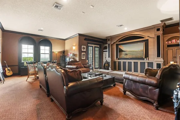 a view of living room filled with furniture and large windows