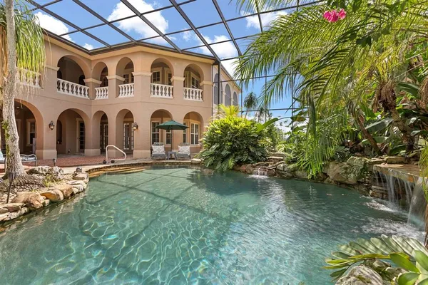 an aerial view of a house with outdoor space and lake view