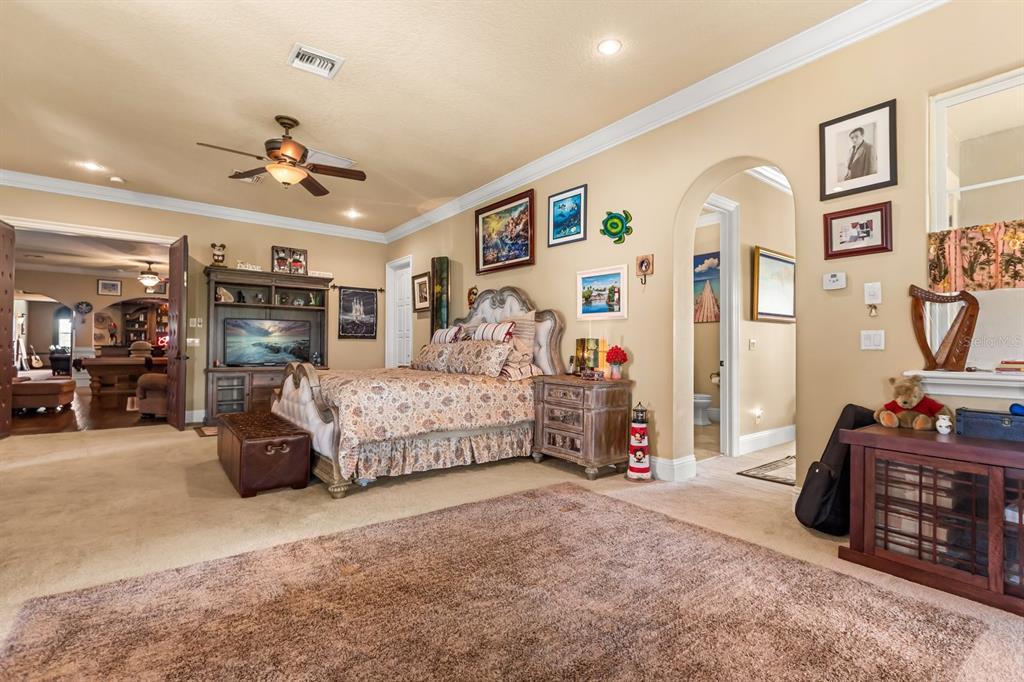 9400 Laws Road Clermont, FL 34714 - Photo 54 of 58 a bedroom with bed and a large mirror