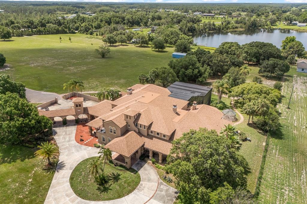 9400 Laws Road Clermont, FL 34714 - Photo 7 of 58 an aerial view of a house with outdoor space and lake view