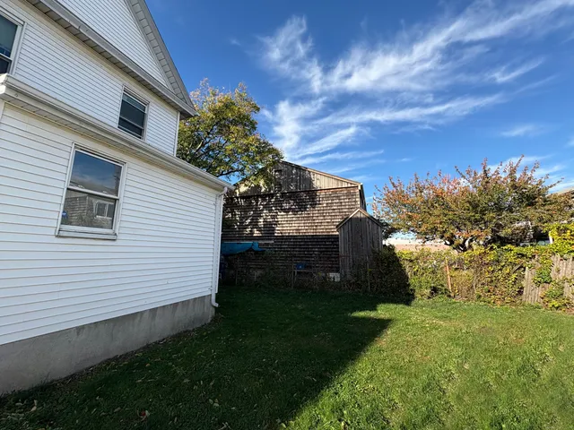 a view of a backyard with plants and a garden