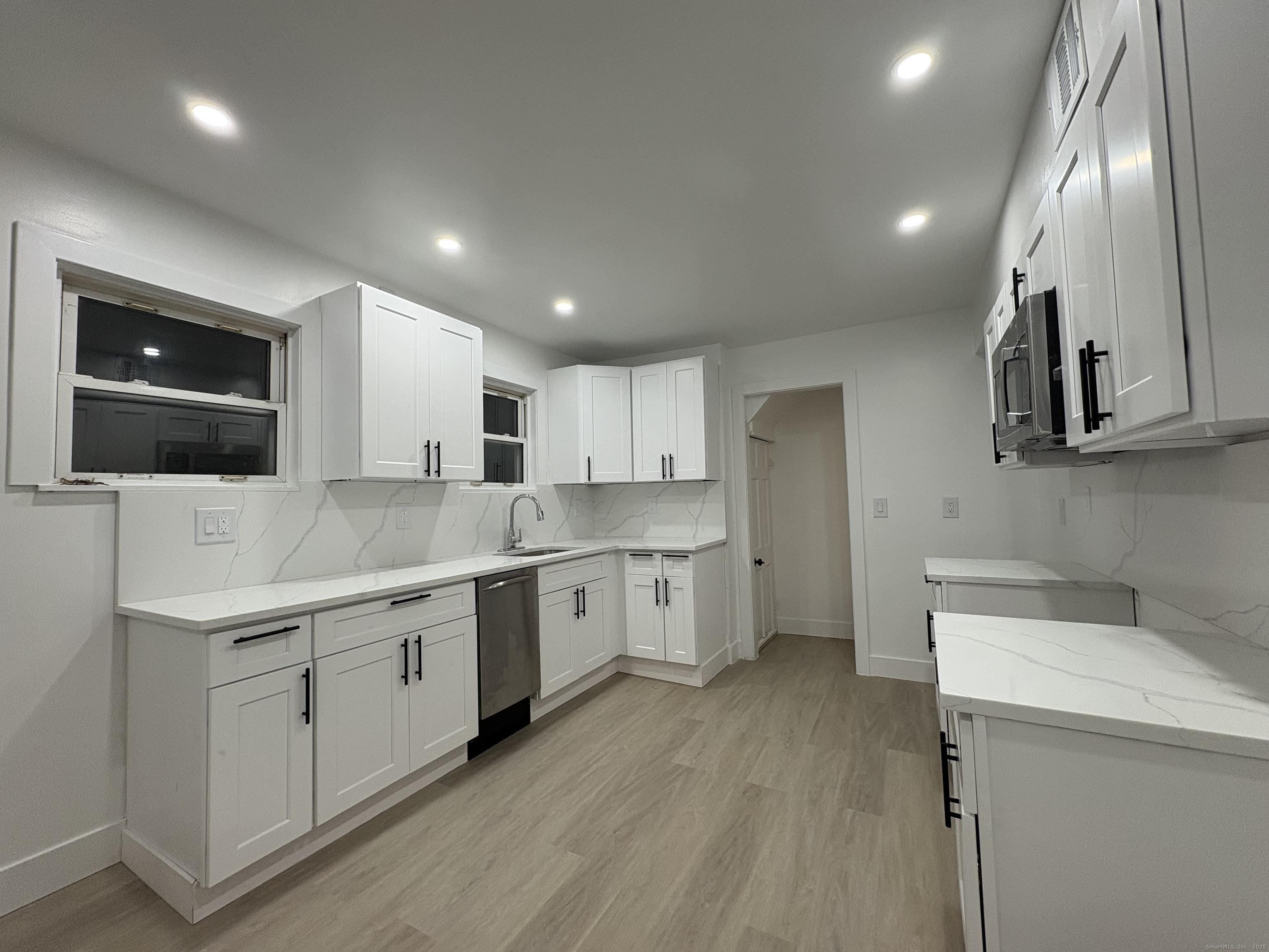 25 Deforest Avenue Bridgeport, CT 06607 - Photo 4 of 11 a kitchen with a sink stainless steel appliances and cabinets