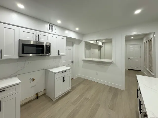 a view of a kitchen with a sink and a stove top oven