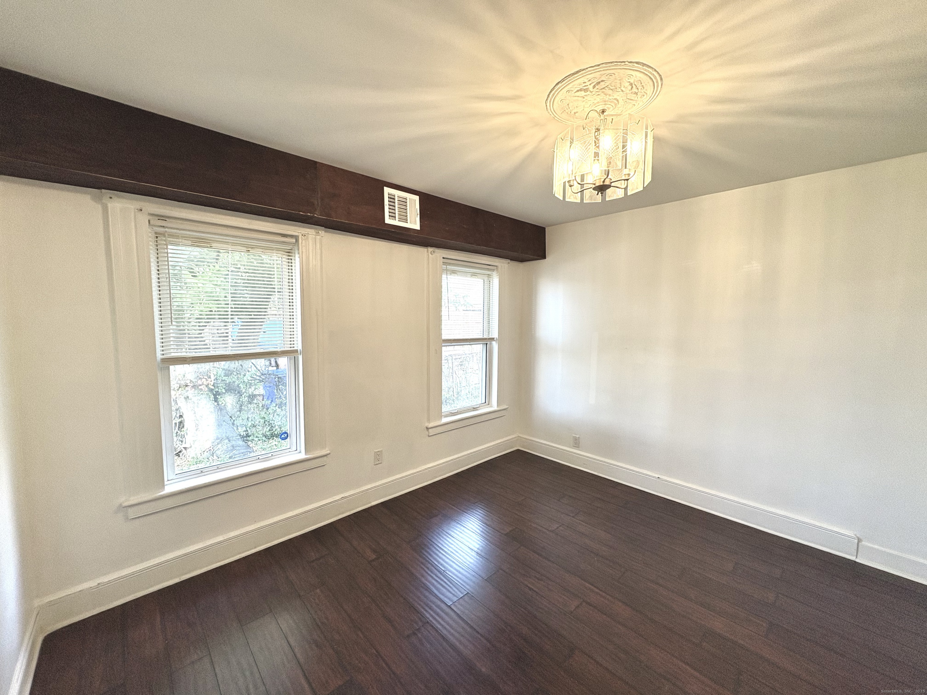 25 Deforest Avenue Bridgeport, CT 06607 - Photo 6 of 11 a view of an empty room with wooden floor and a window