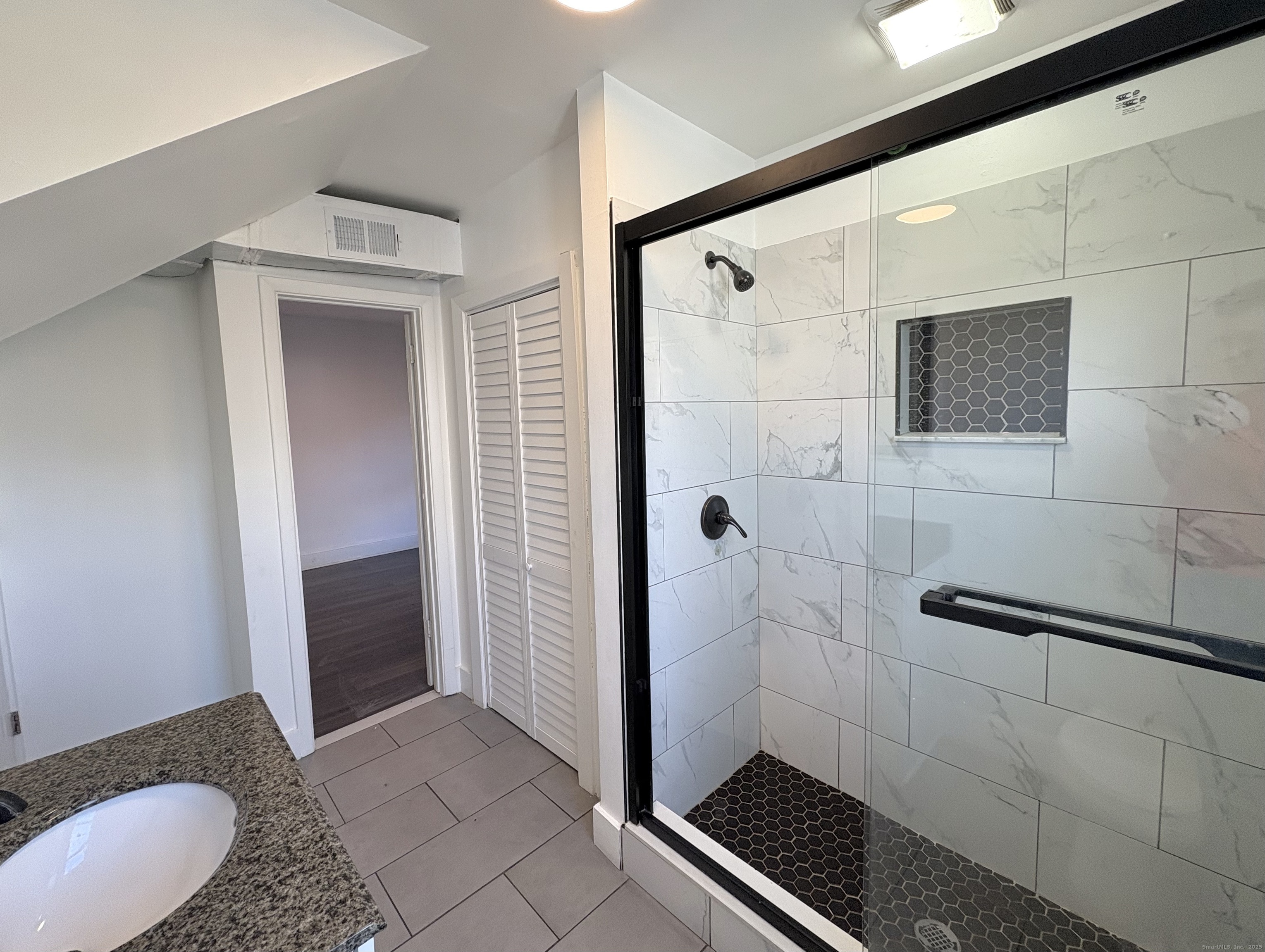 25 Deforest Avenue Bridgeport, CT 06607 - Photo 10 of 11 a bathroom with a granite countertop shower