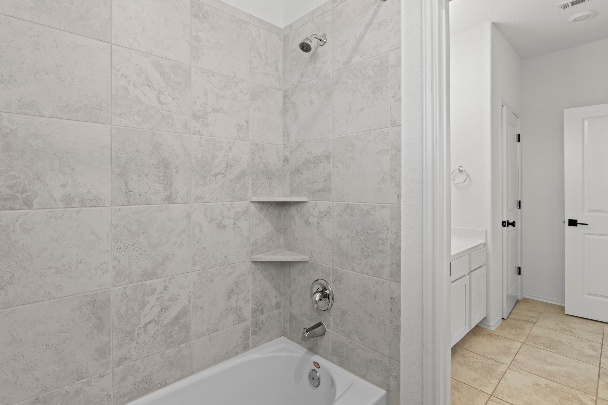 1101 Skeeter Cove Austin, TX 78748 - Photo 24 of 31 A well-appointed bath with tiled walls and an inviting soaking tub for unwinding.