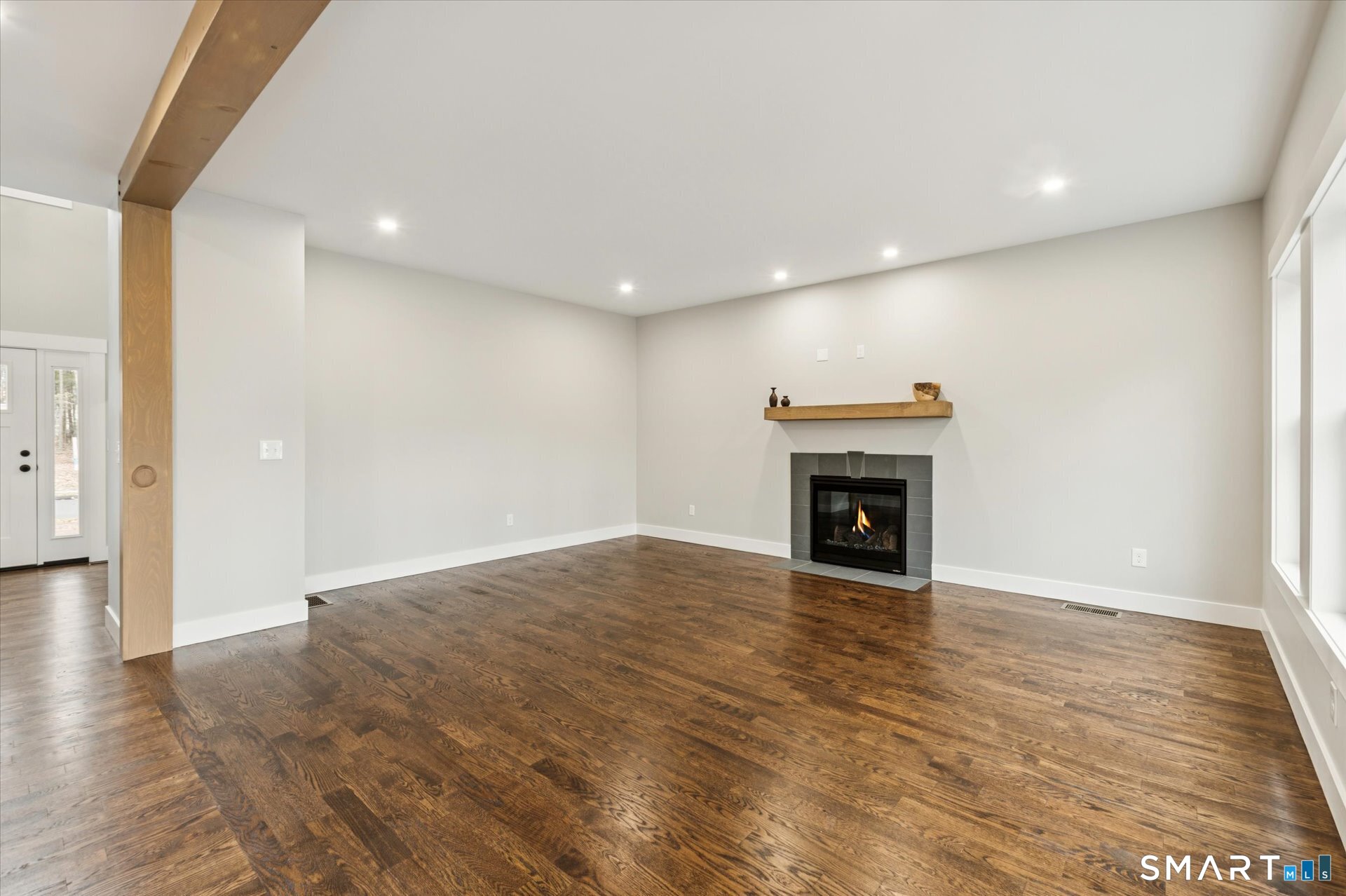 592 Village Street Bristol, CT 06010 - Photo 17 of 38 a view of an empty room with wooden floor and a window