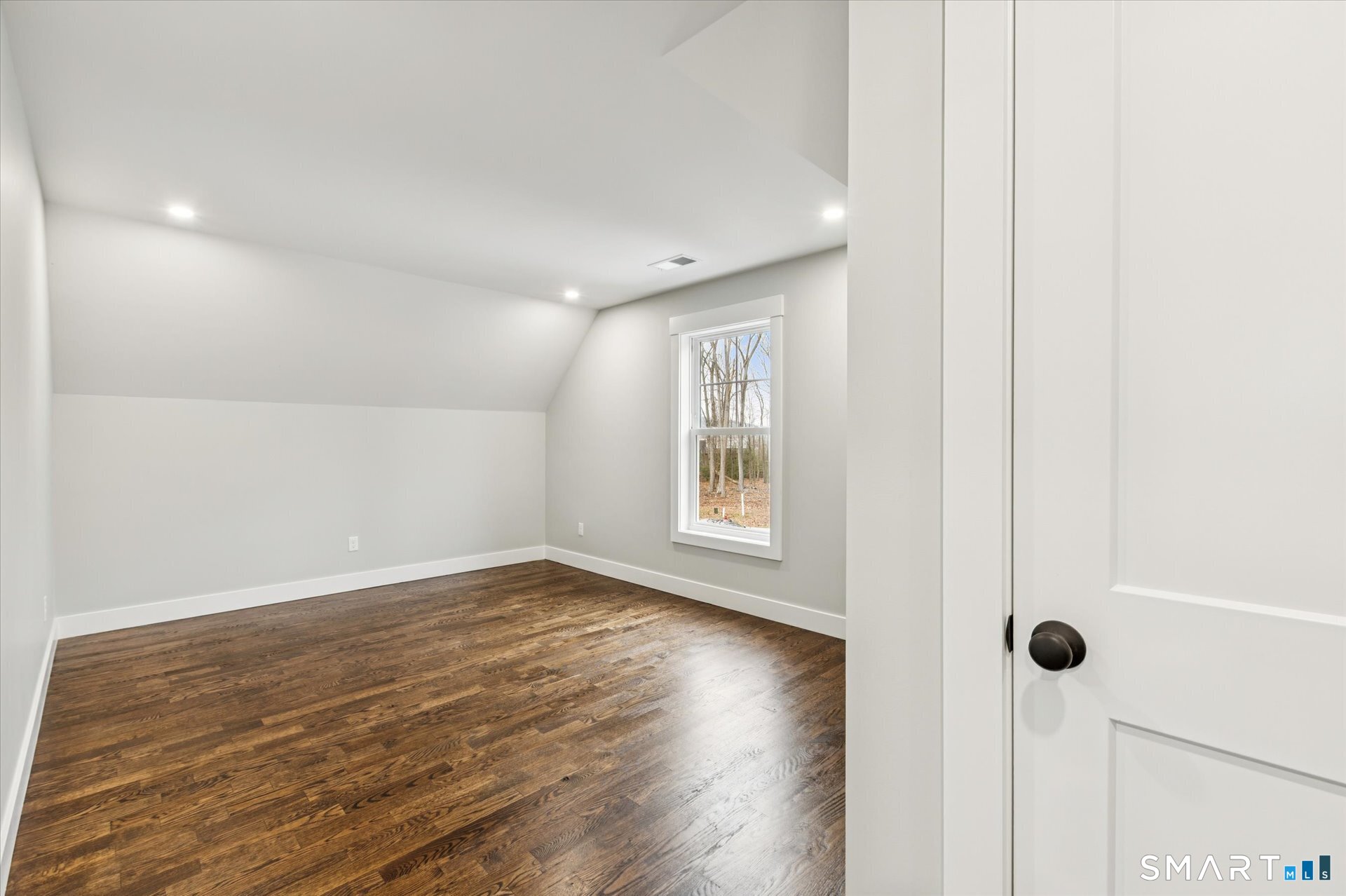 592 Village Street Bristol, CT 06010 - Photo 25 of 38 a view of an empty room with wooden floor and a window