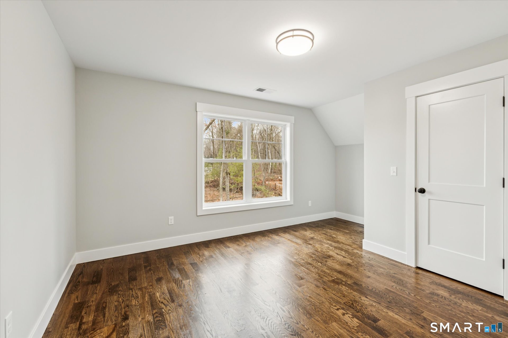 592 Village Street Bristol, CT 06010 - Photo 26 of 38 an empty room with wooden floor and windows