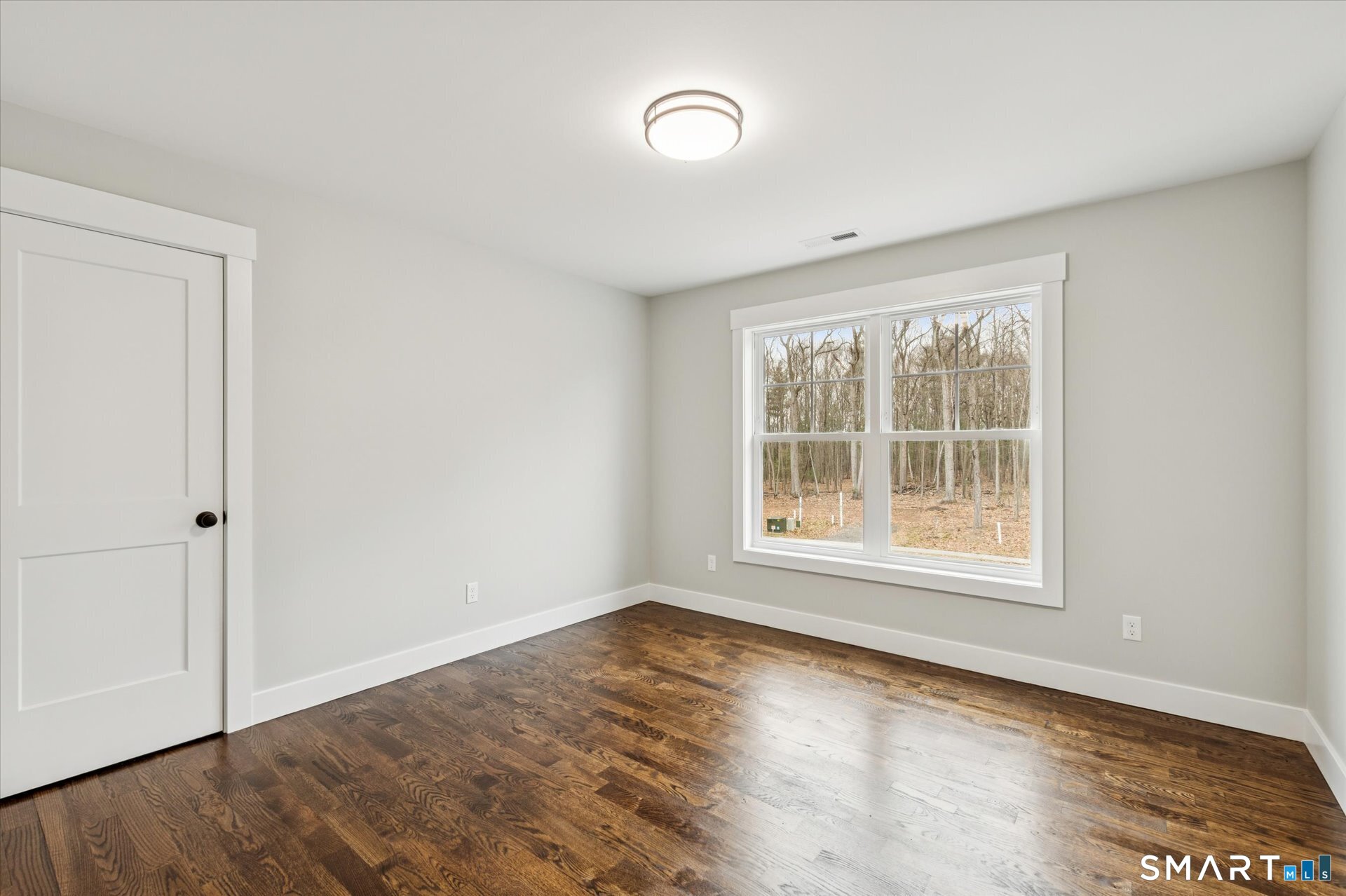 592 Village Street Bristol, CT 06010 - Photo 28 of 38 an empty room with wooden floor and windows