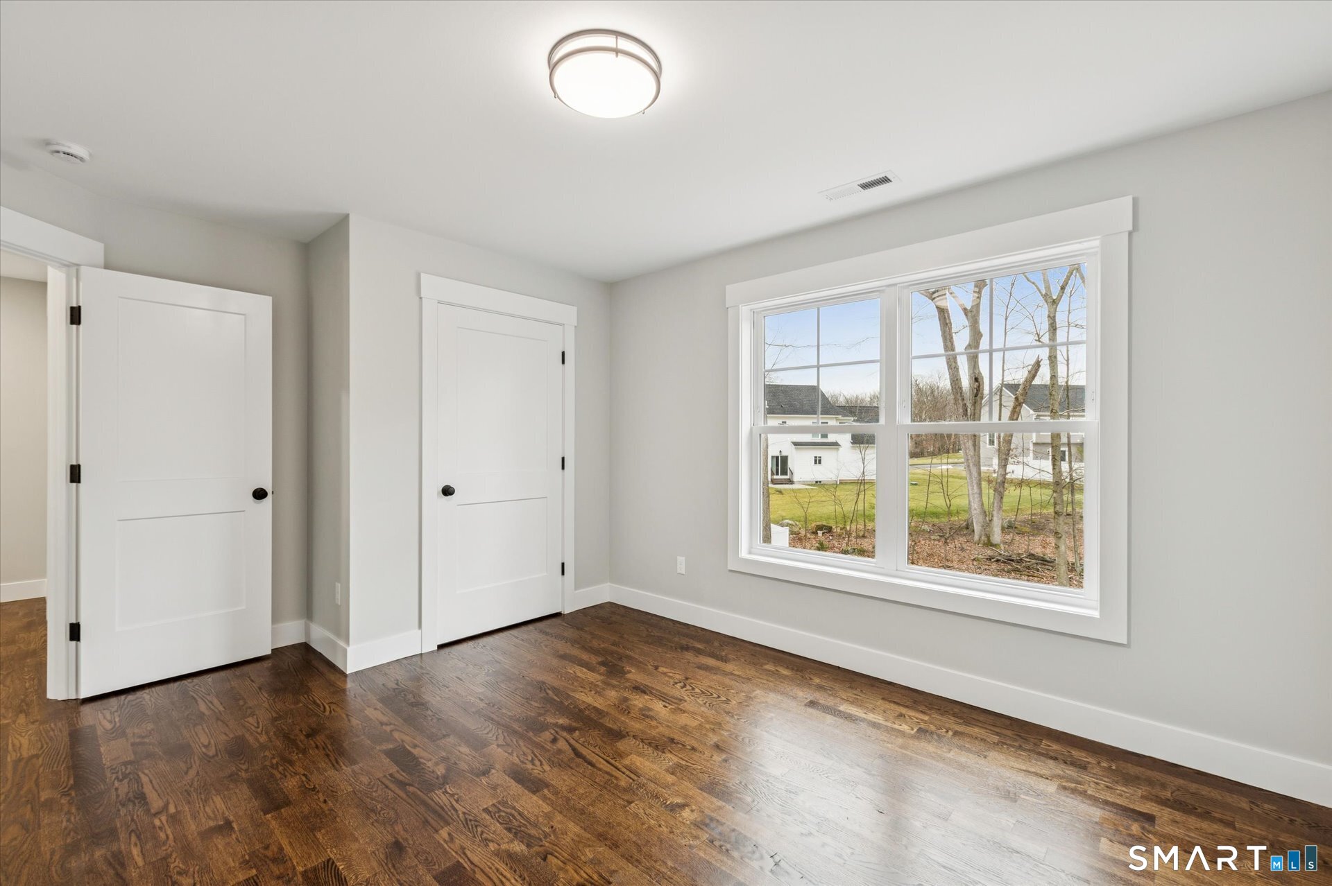 592 Village Street Bristol, CT 06010 - Photo 30 of 38 a view of an empty room with wooden floor and a window