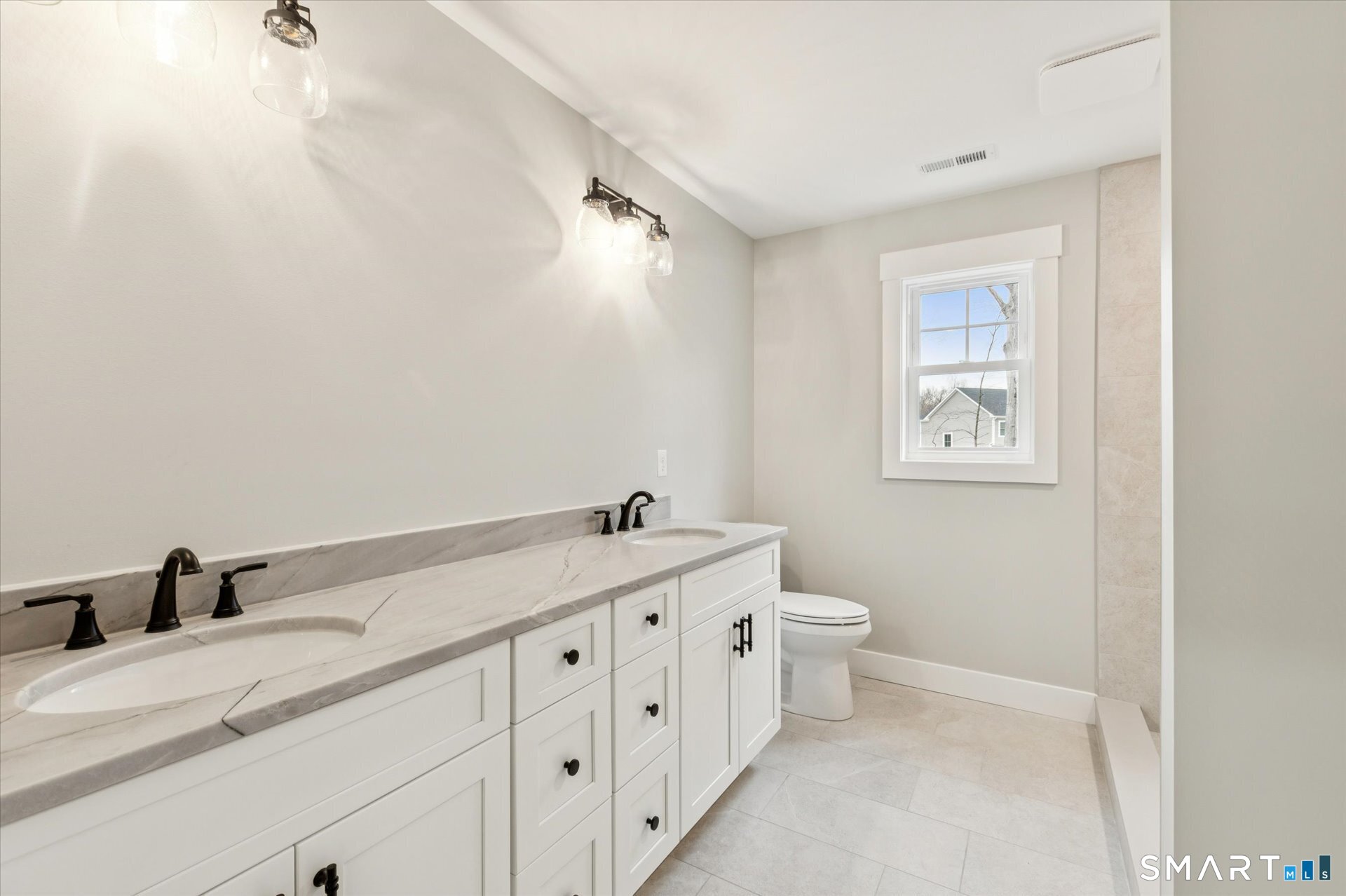 592 Village Street Bristol, CT 06010 - Photo 37 of 38 a bathroom with a granite countertop sink mirror vanity and toilet
