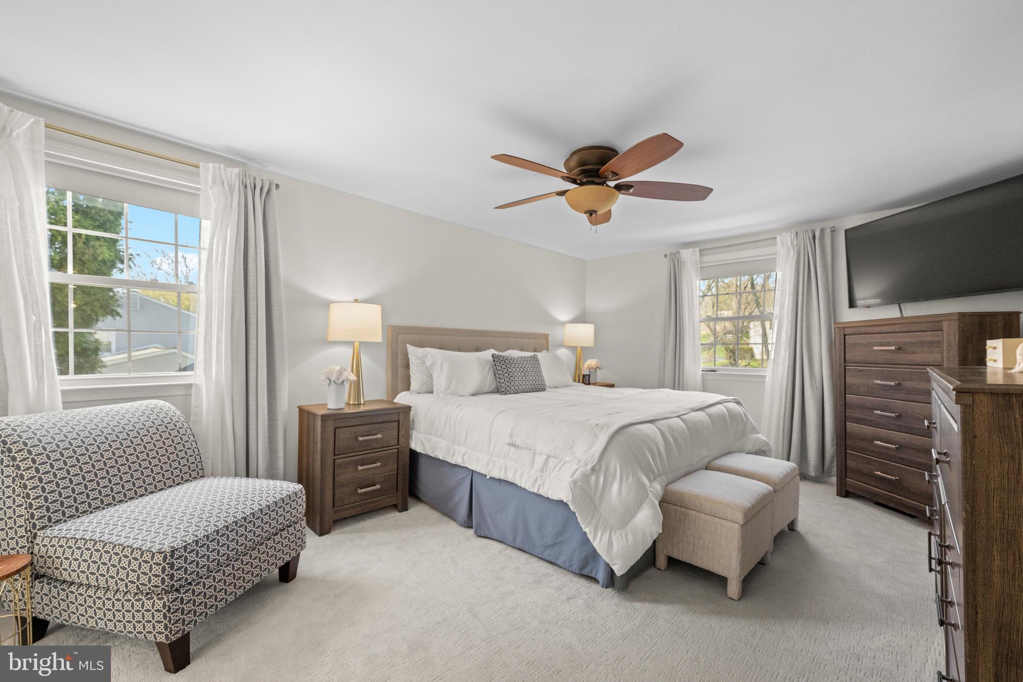 174 Coldstream Drive Berwyn, PA 19312 - Photo 21 of 40 a spacious bedroom with a bed a couch and a chandelier