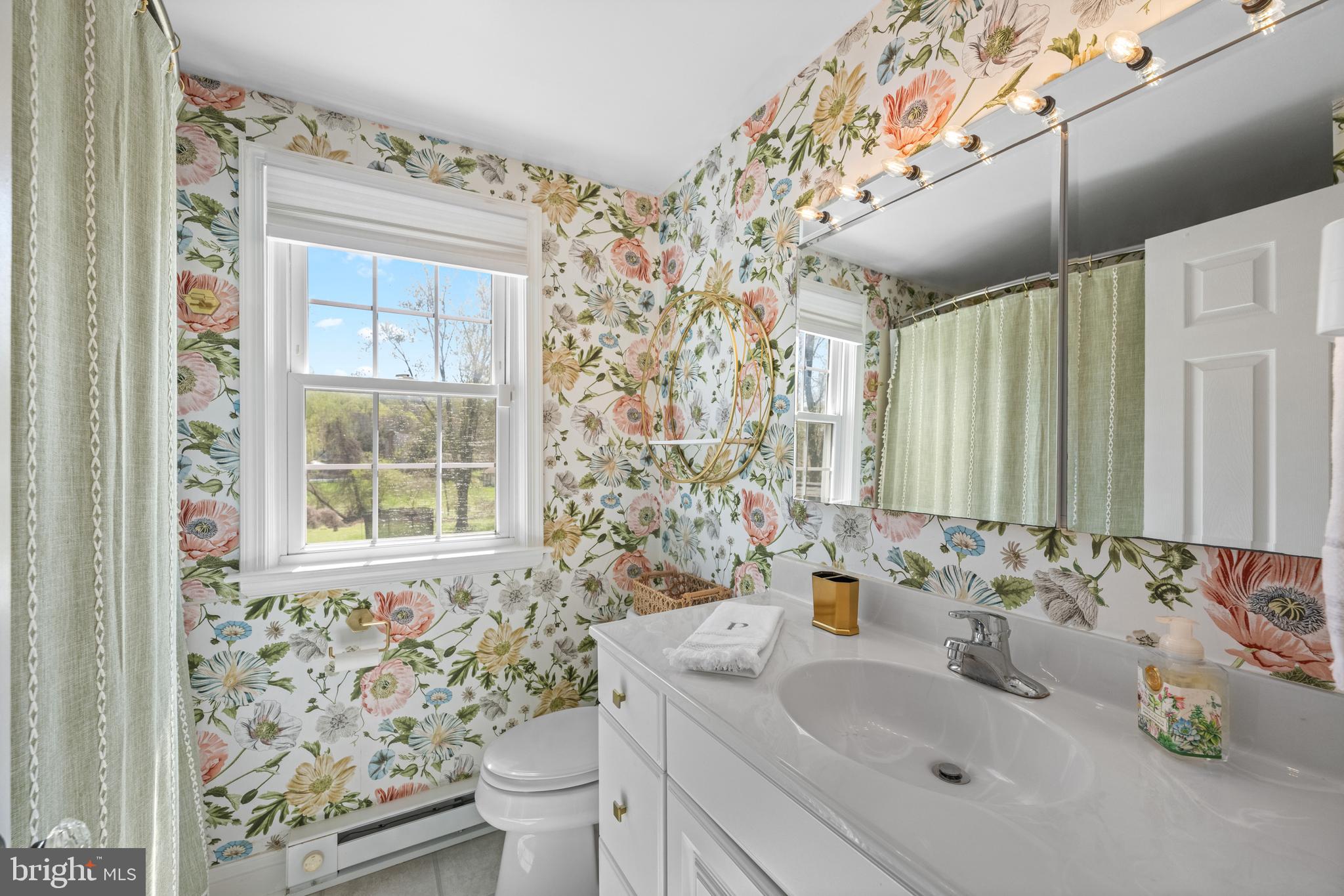 174 Coldstream Drive Berwyn, PA 19312 - Photo 26 of 40 a bathroom with a sink toilet a mirror and shower