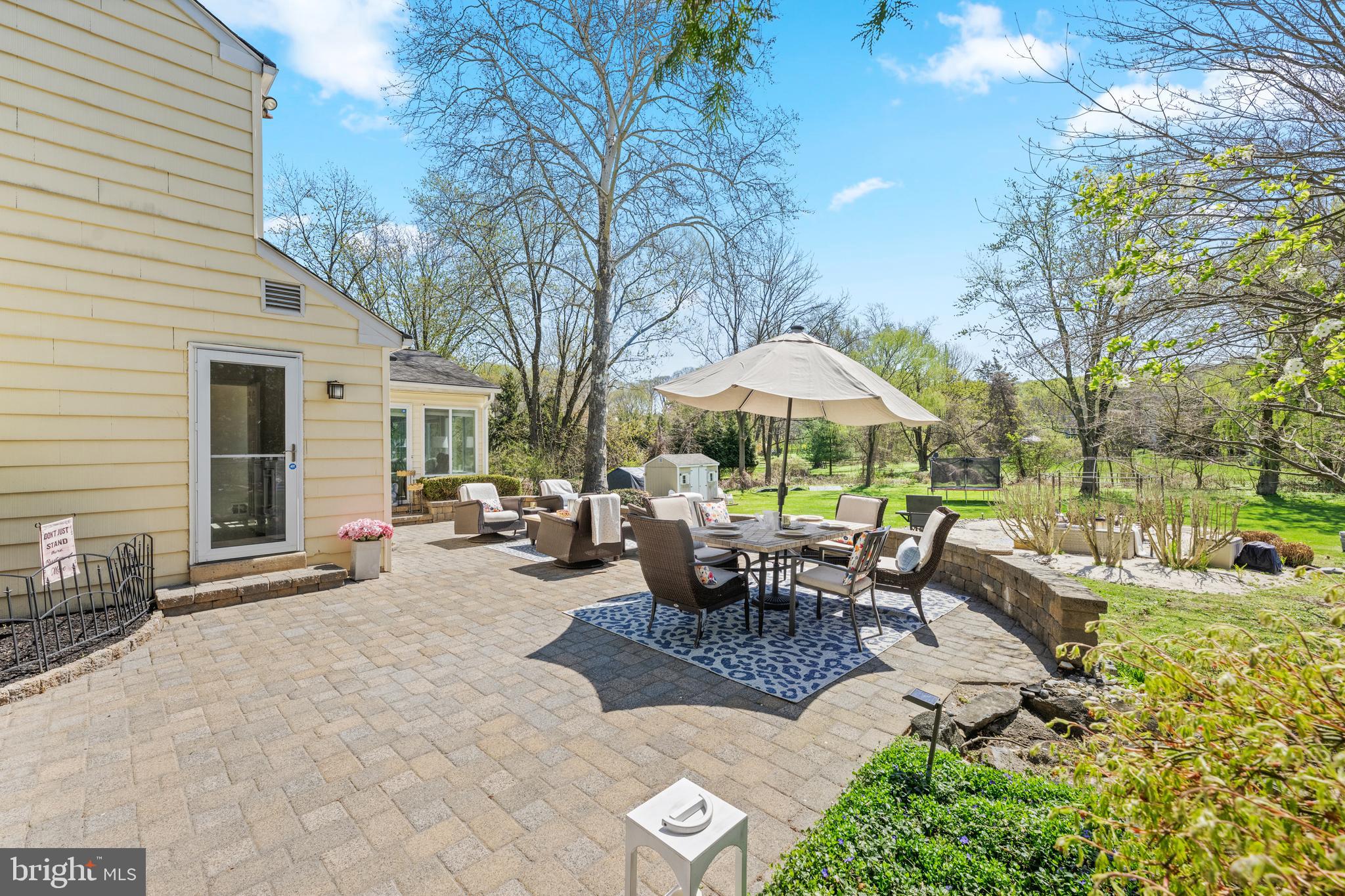 174 Coldstream Drive Berwyn, PA 19312 - Photo 36 of 40 a view of a patio with couches table and chairs under an umbrella