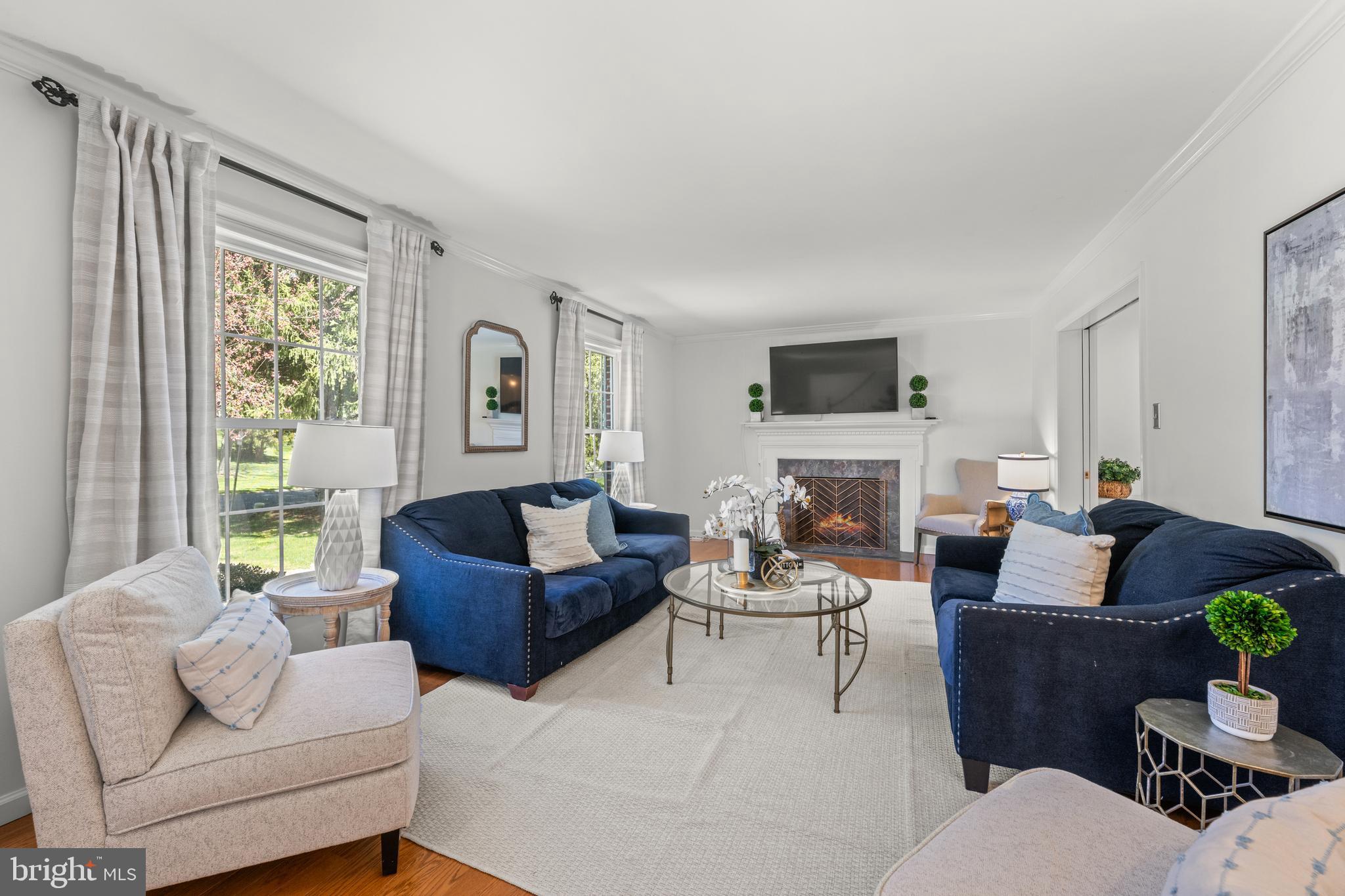 174 Coldstream Drive Berwyn, PA 19312 - Photo 4 of 40 a living room with furniture a large window and a fireplace