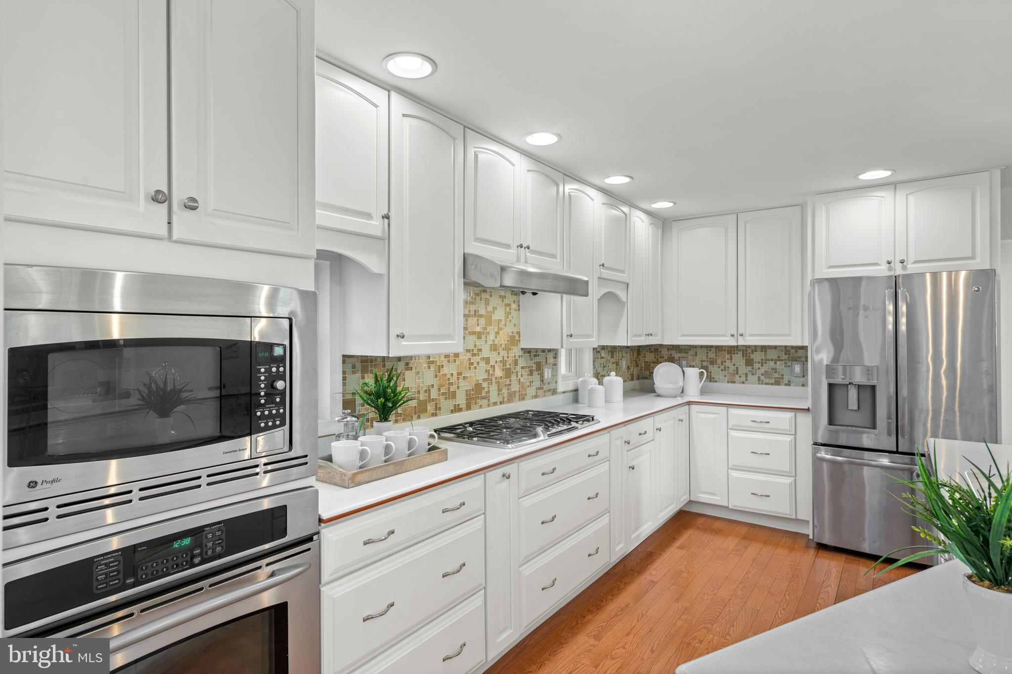 174 Coldstream Drive Berwyn, PA 19312 - Photo 7 of 40 a kitchen with granite countertop white cabinets and stainless steel appliances