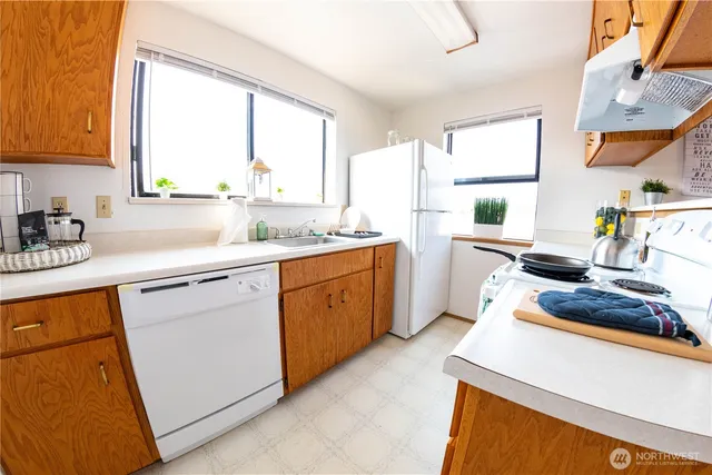 a kitchen with a sink stove and cabinets