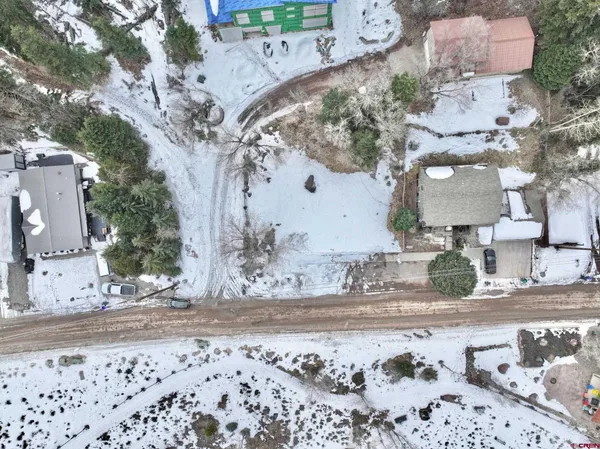 an aerial view of a house with a yard and garden