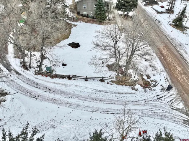 a view of a house with a snow on the road