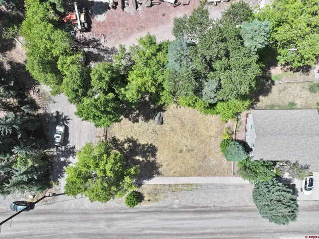 an aerial view of a house with a yard and garden